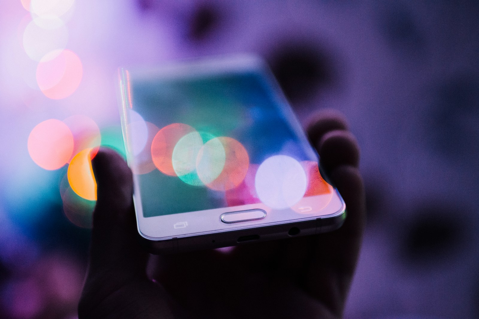 Photo by Rodion Kutsaiev person holding smartphone