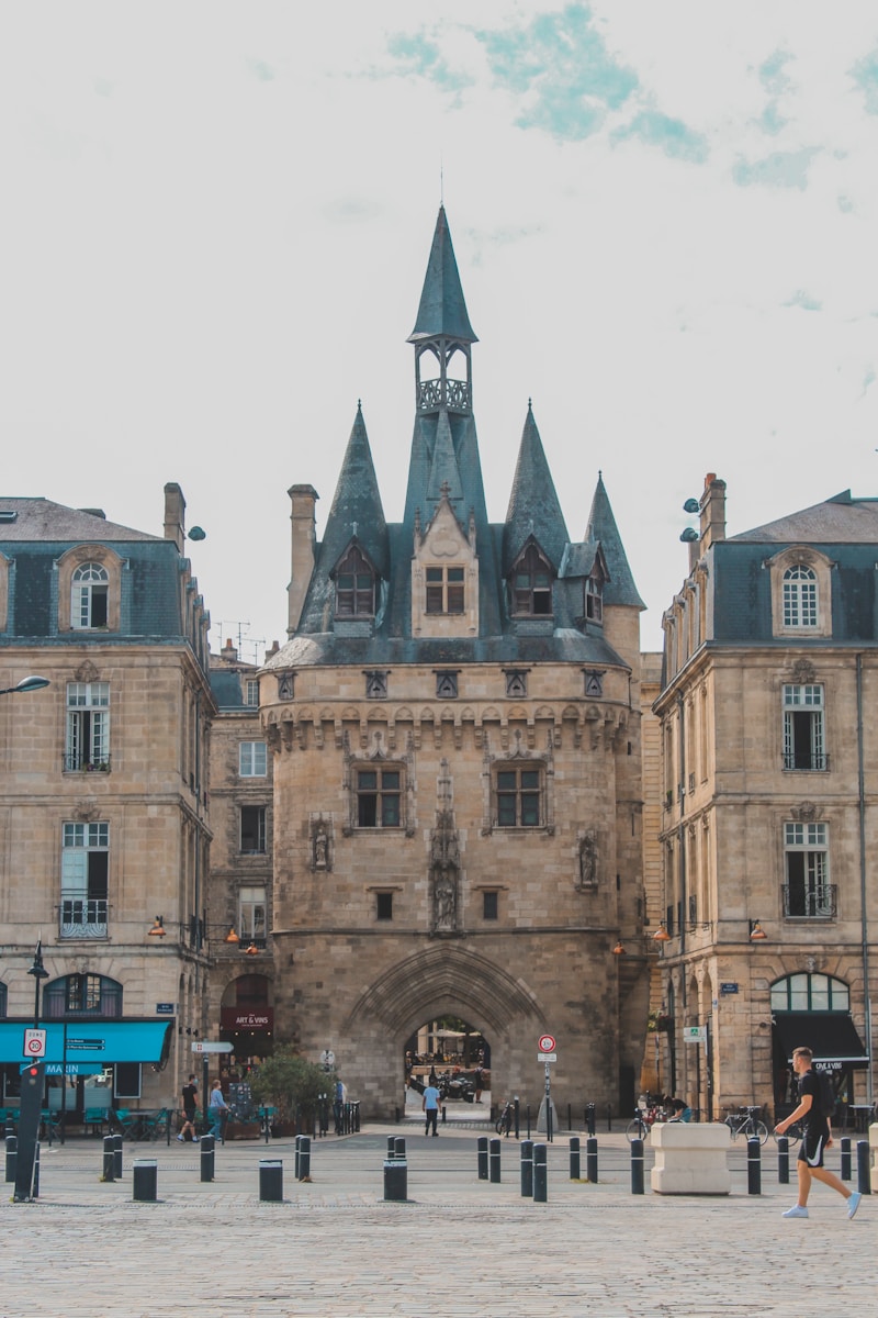 Photo by Árpád Czapp a large stone building with a clock tower