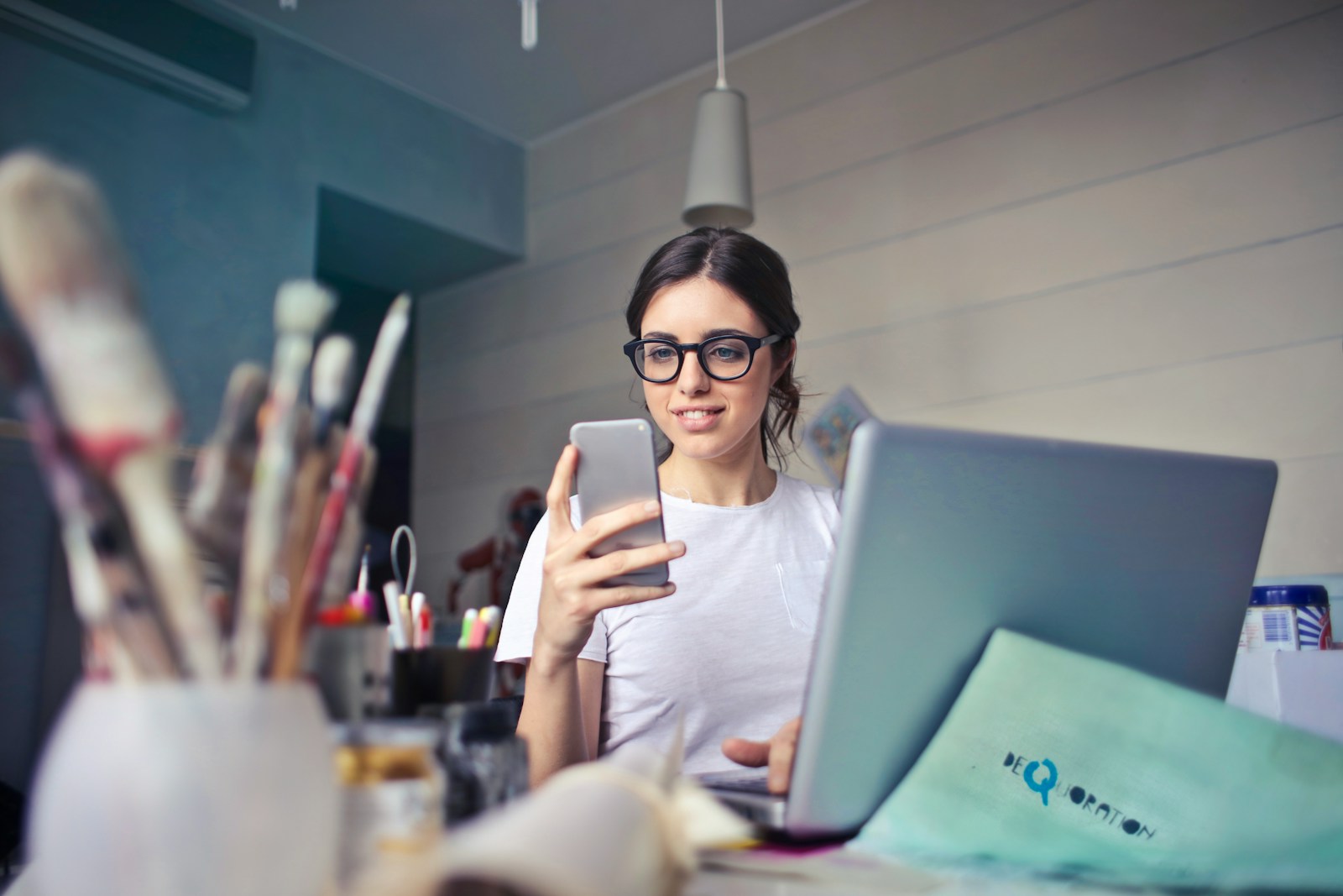 Photo by bruce mars woman in white shirt using smartphone