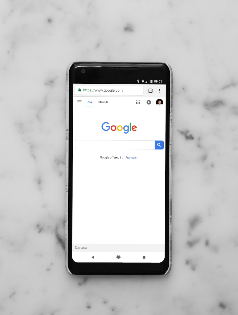 Photo by charlesdeluvio black Android smartphone showing google site on white surface