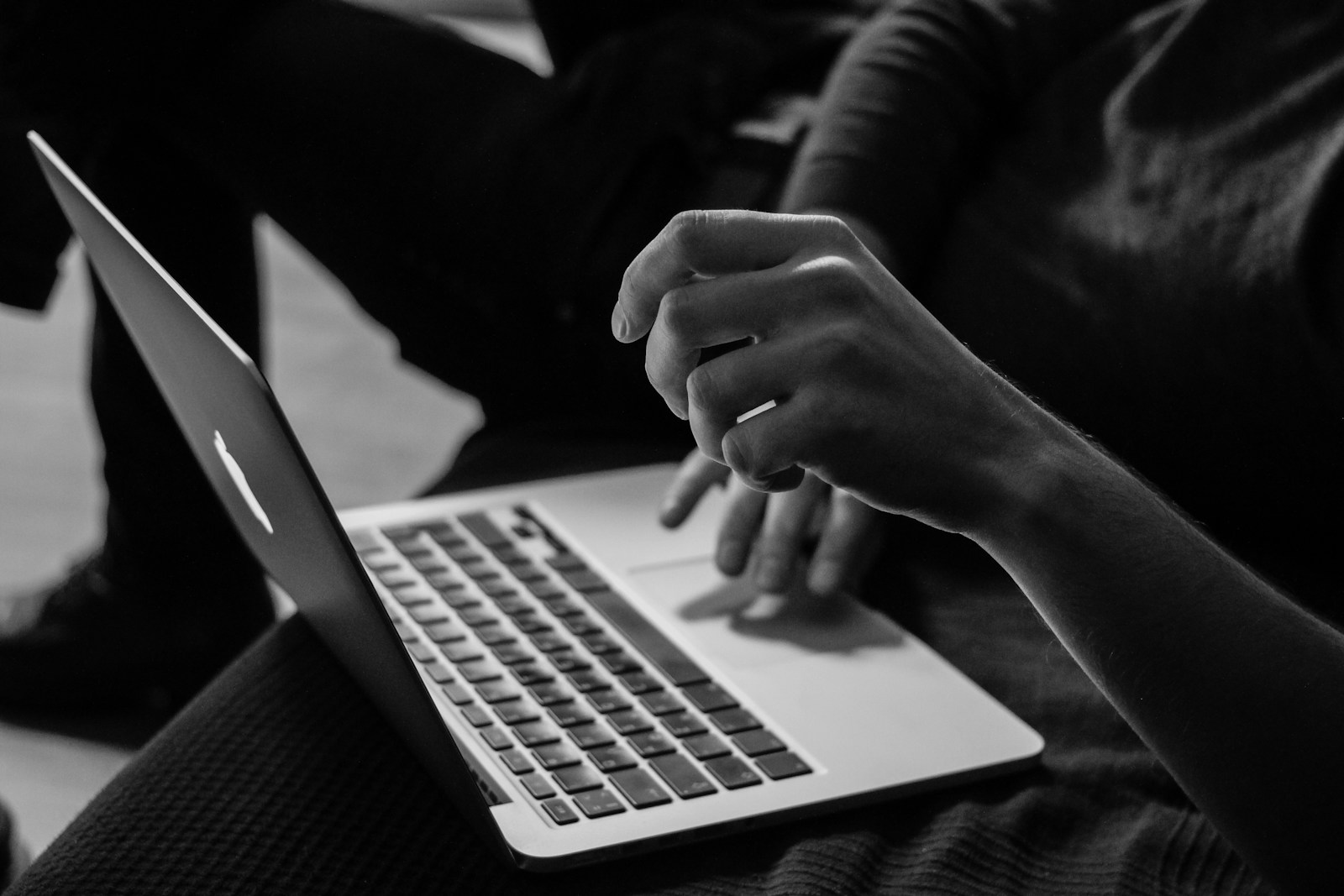Photo by Sergey Zolkin grayscale photo of person using MacBook